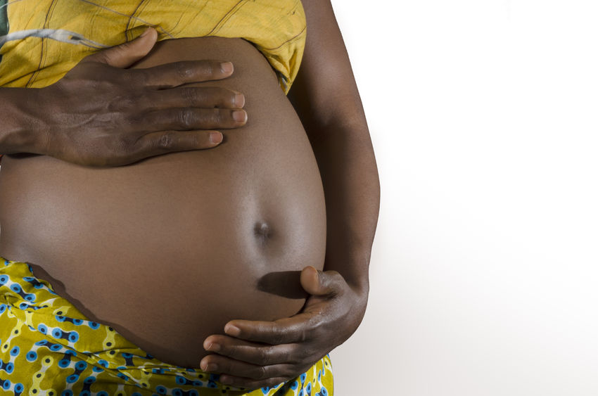 25035297 - pregnant african woman, studio shot